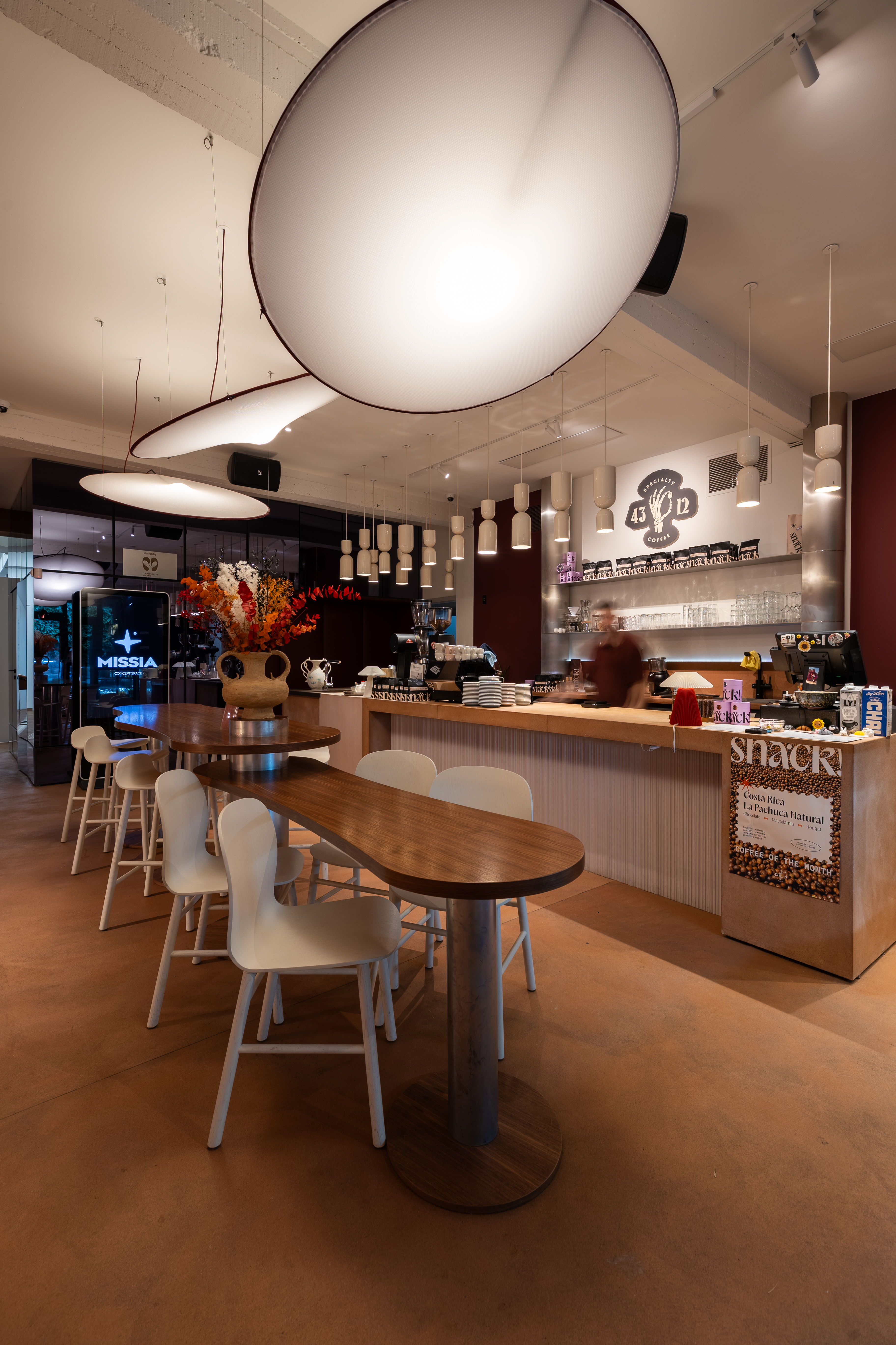 Coffee bar beneath ceramic pendant lamps