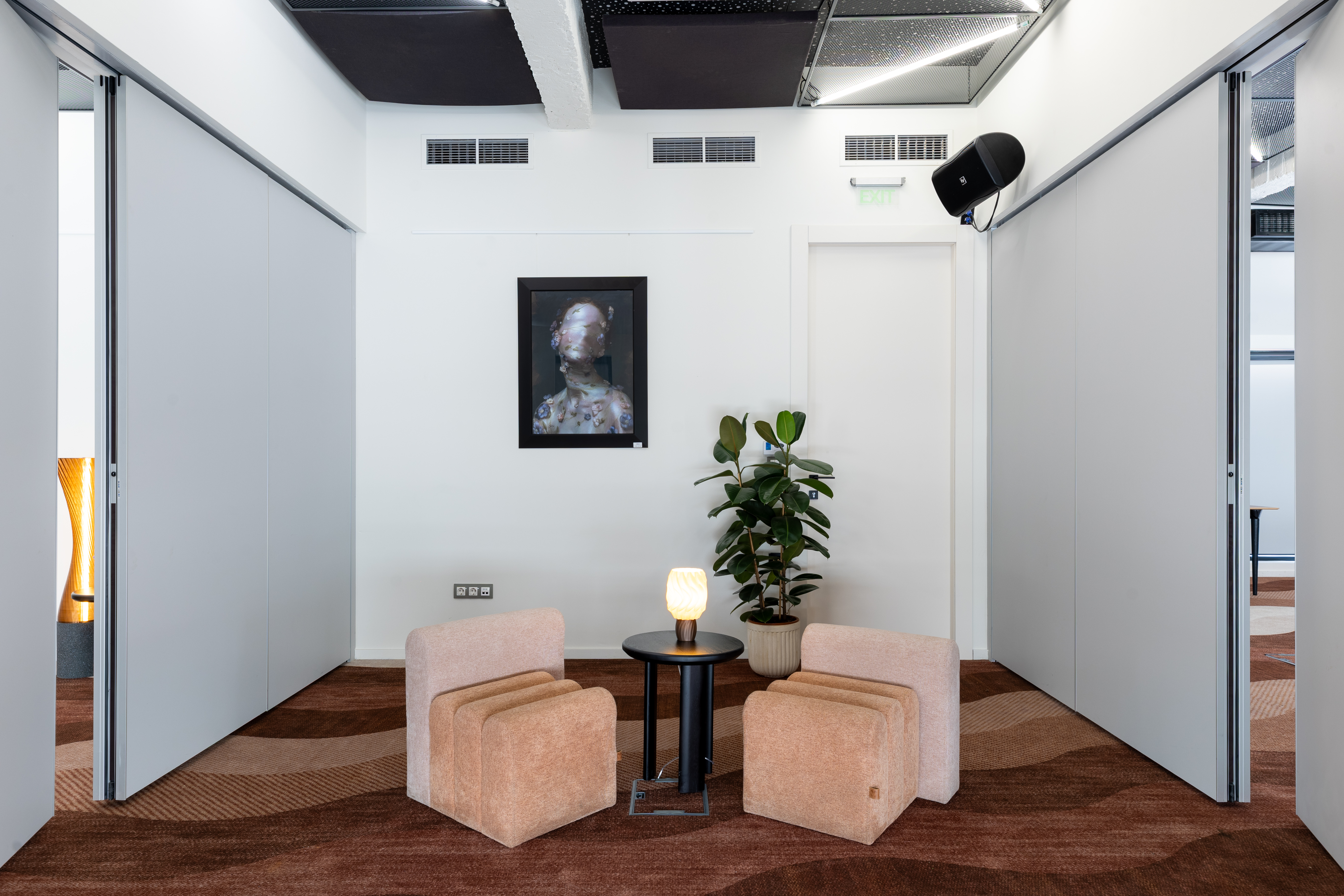 Intimate meeting room with two chairs and lamp