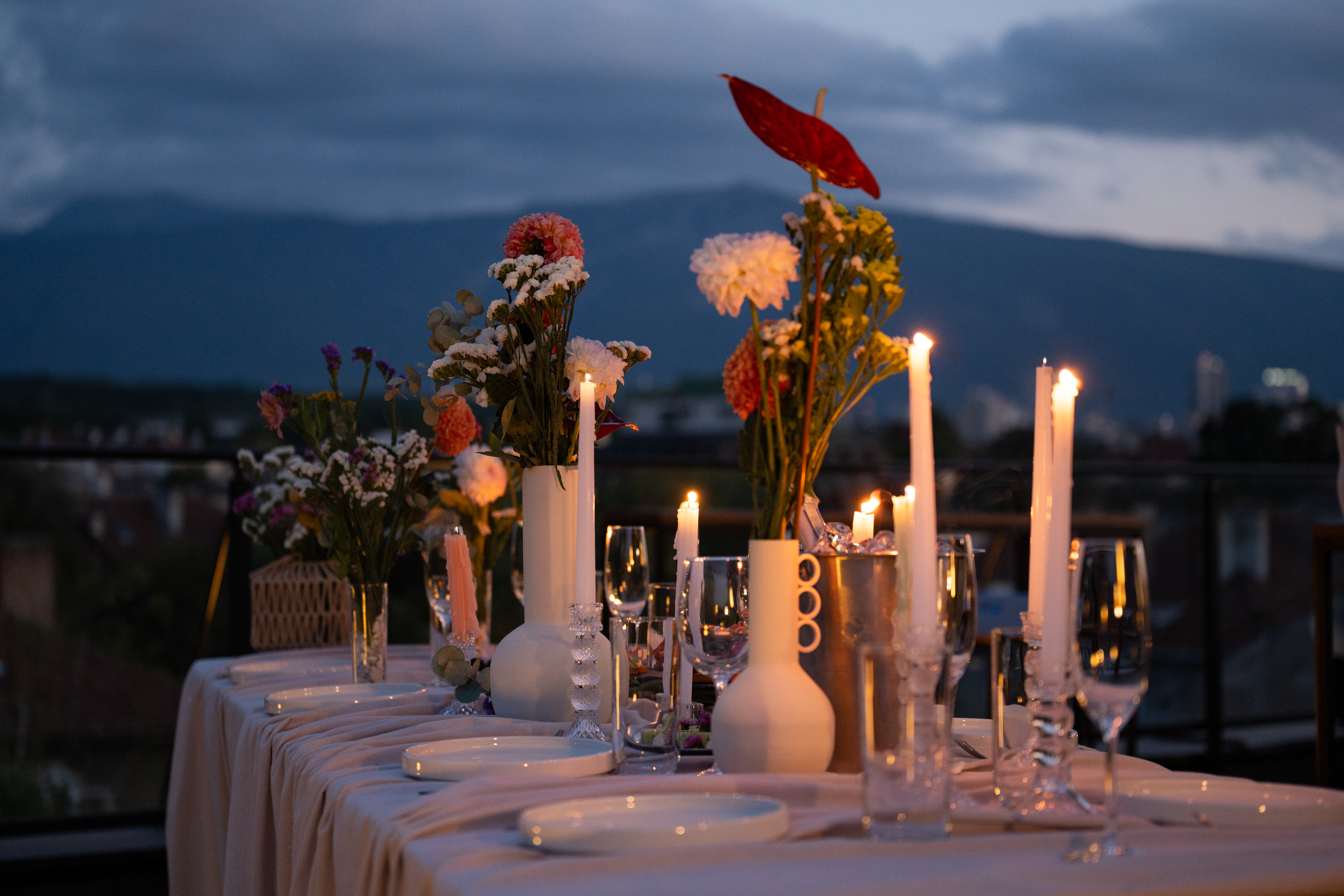 Candlelit rooftop table with Vitosha mountain behind