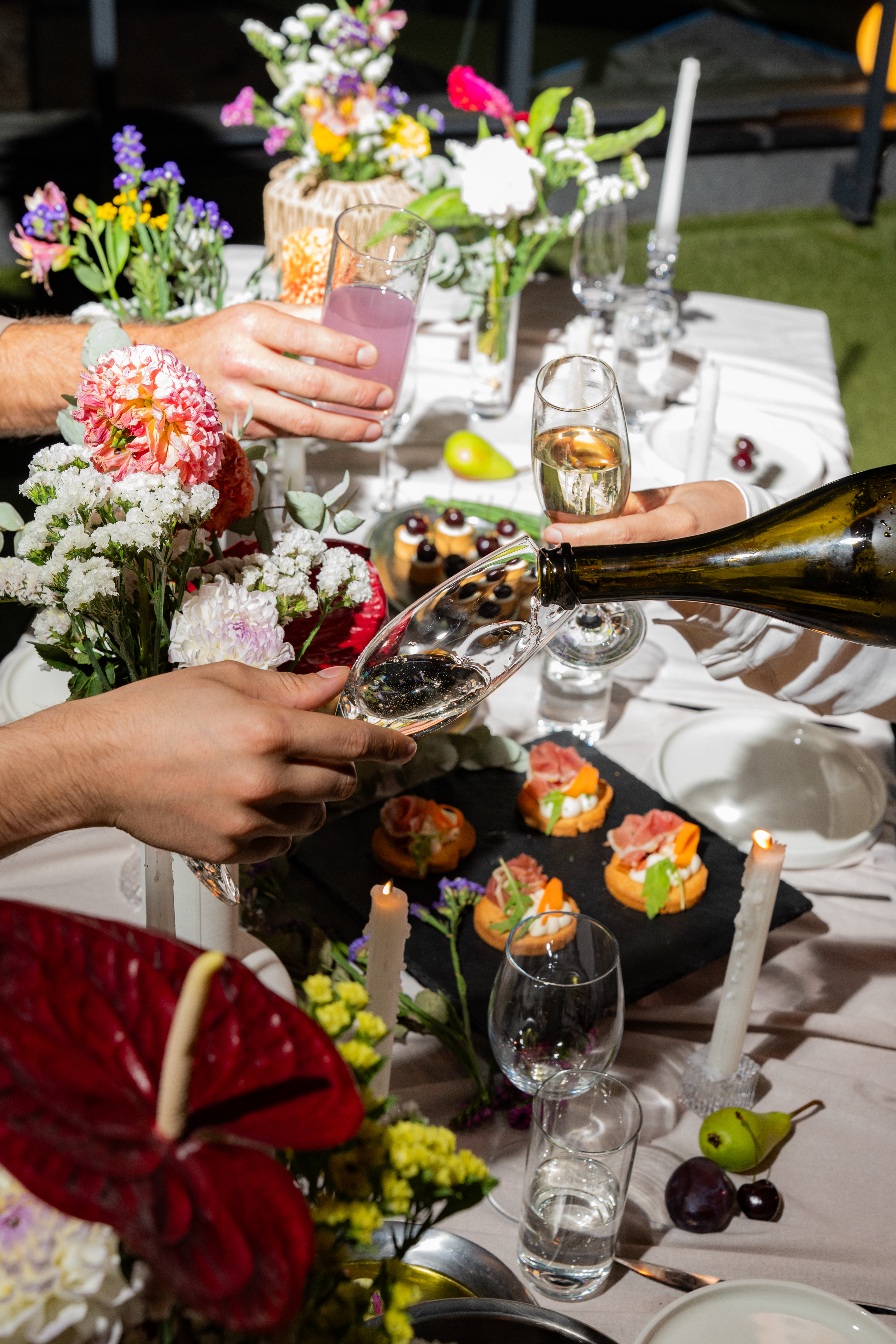 Glasses raised over a dressed table